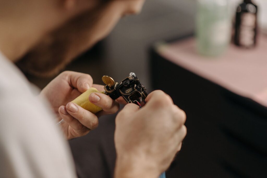 Tattoo artist preparing a coil tattoo machine